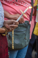 Philippines, Palawan, Puerto Princesa, woman with candle at easter procession