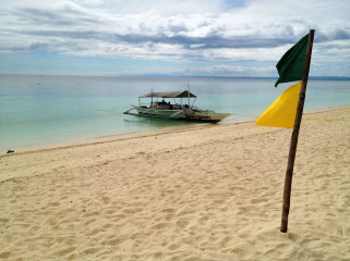 Philippines, Malapascua, Beach with Flag and Boat