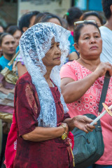 Philippines, Palawan, Puerto Princesa, woman with candle at easter procession