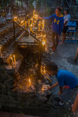 Philippines, Palawan, Puerto Princesa, people lighting candles at church